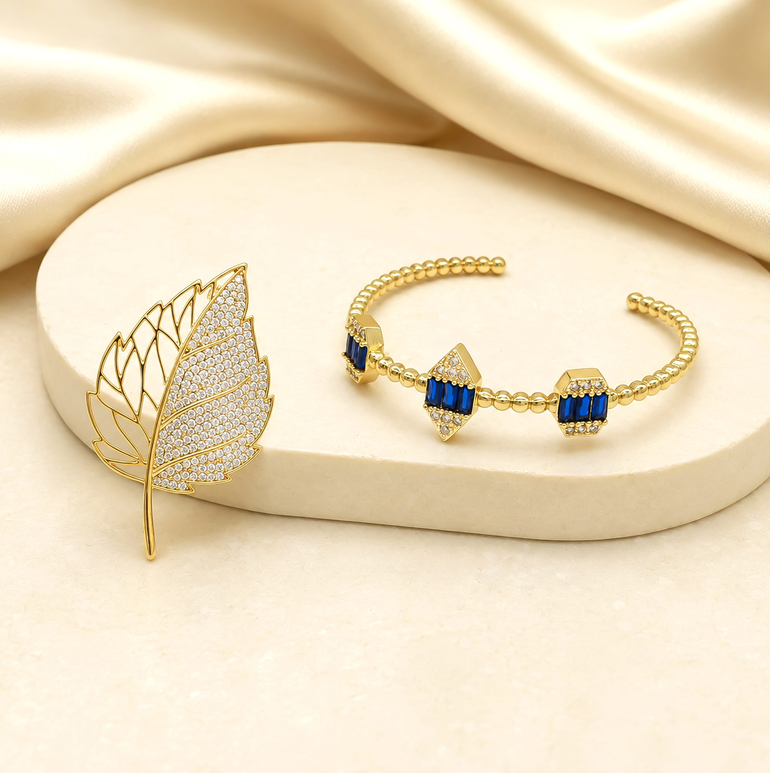 Gold Pave Leaf Brooch & Sapphire Blue Bracelet